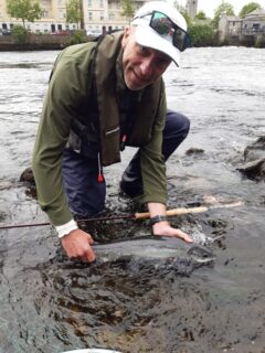 Rob Malcolm about to release a salmon  on the Ridge Pool in Ballina