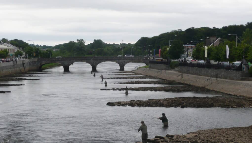 People fishing a river