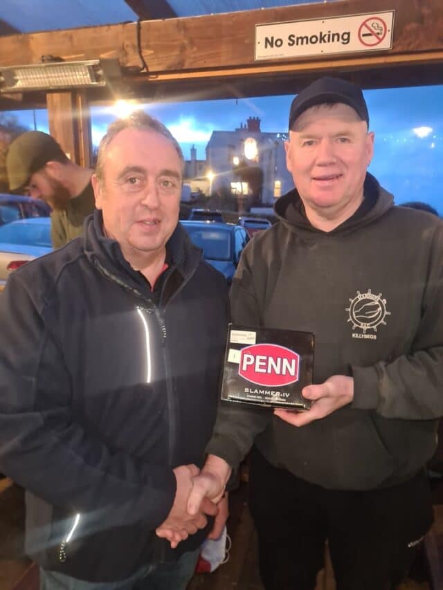 Overall winner Nicholas McNeill (left) winning a penn Slammer receiving his prize from Mariners chairman John Cunningham (right)