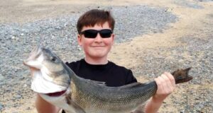 Super 76.5cm bass for young first-time angler Seán