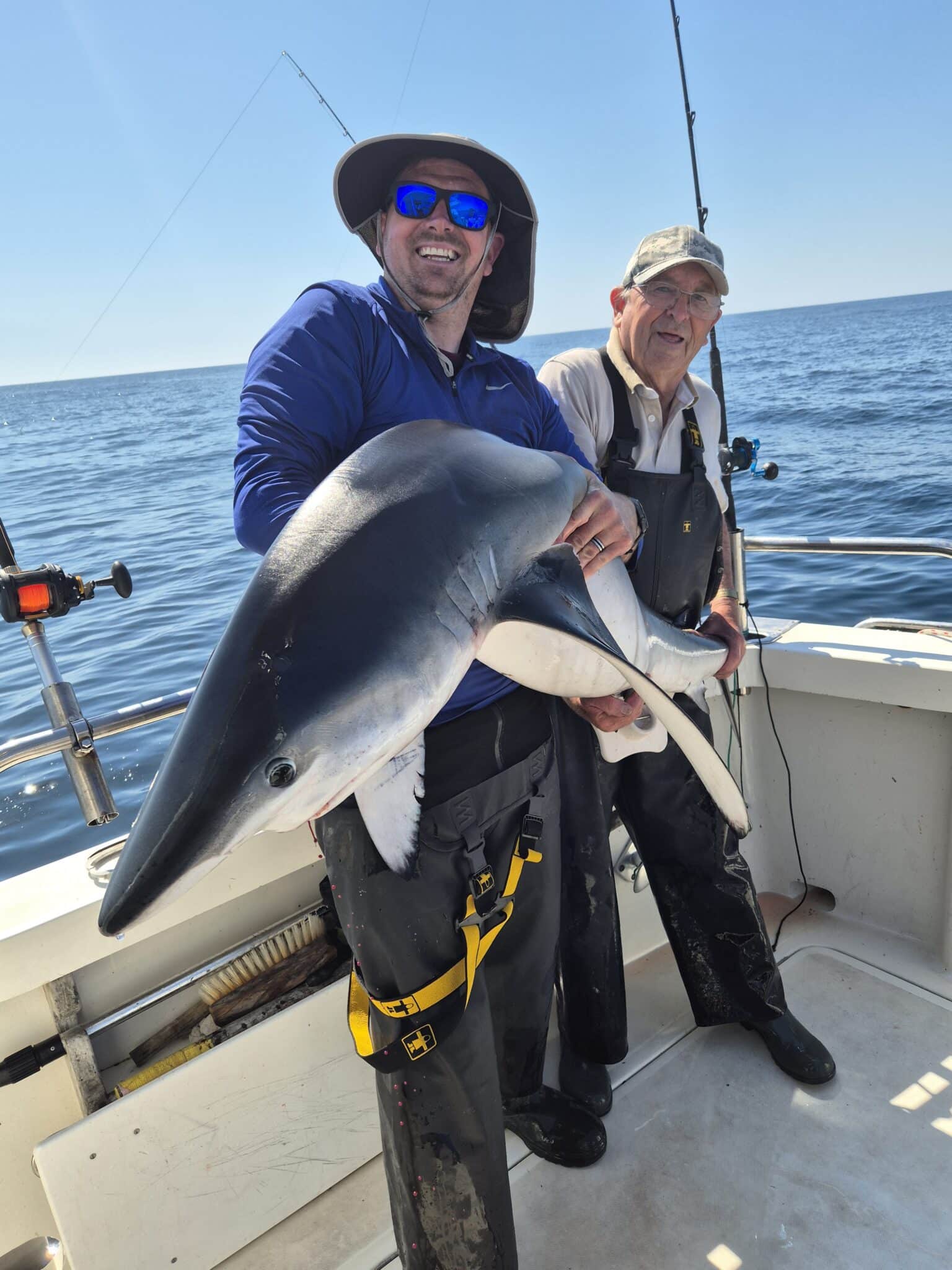 Son, Will, helps dad, Brian with a big shark
